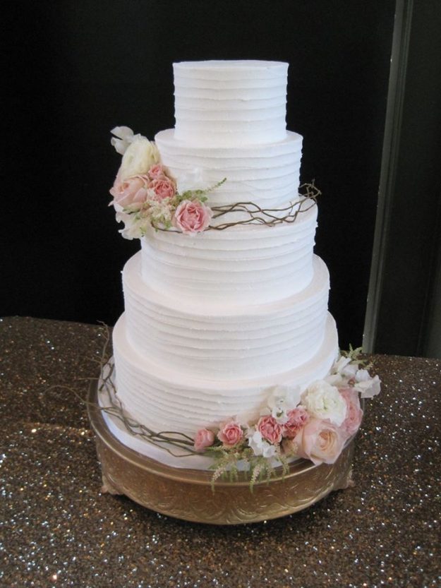 Simple white wedding cake with flowers by Elena's Cakes