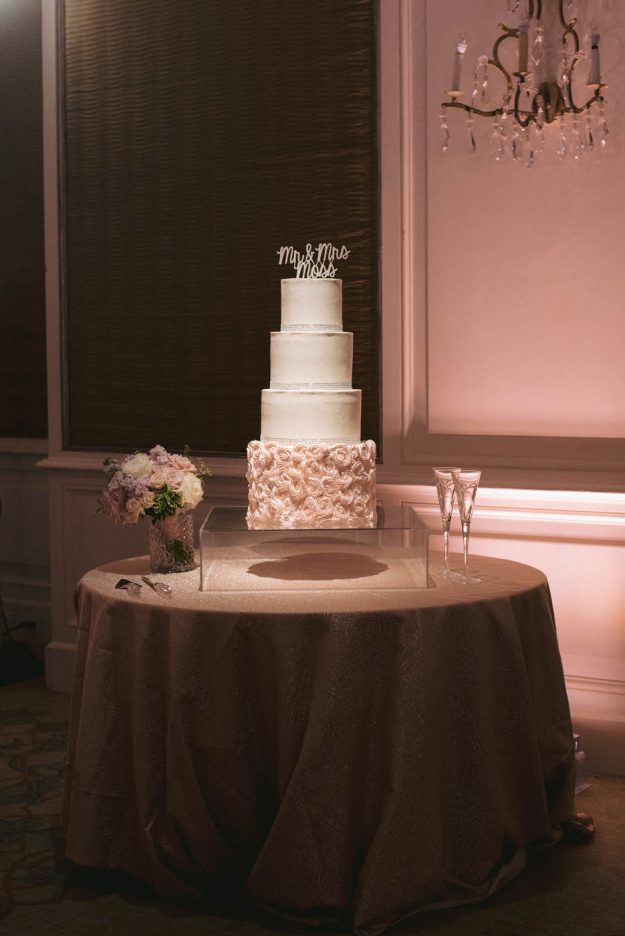 wedding cake on clear pedestal